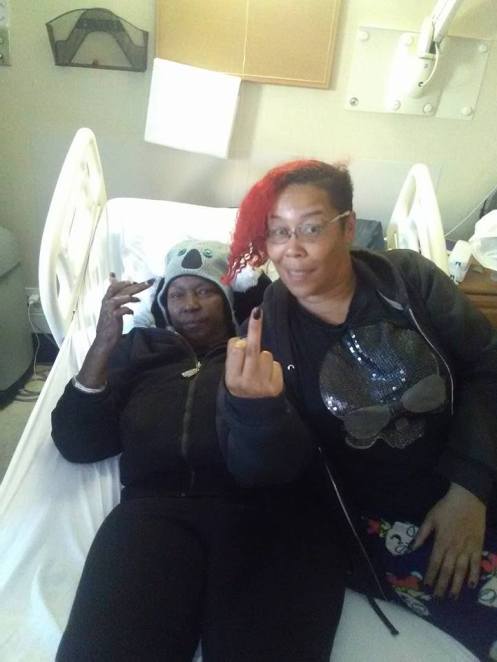 Carolyn and Sumiko Saulson flip off the camera at Windsor Care in Vallejo