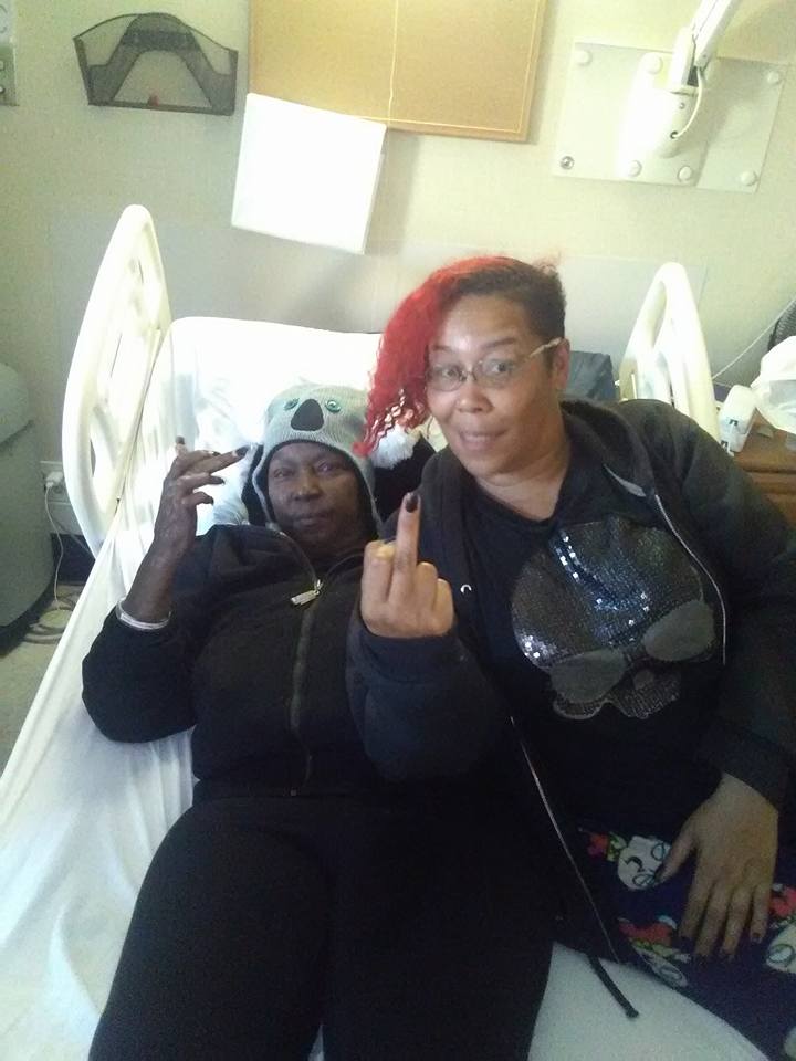 Carolyn and Sumiko Saulson flip off the camera at Windsor Care in Vallejo